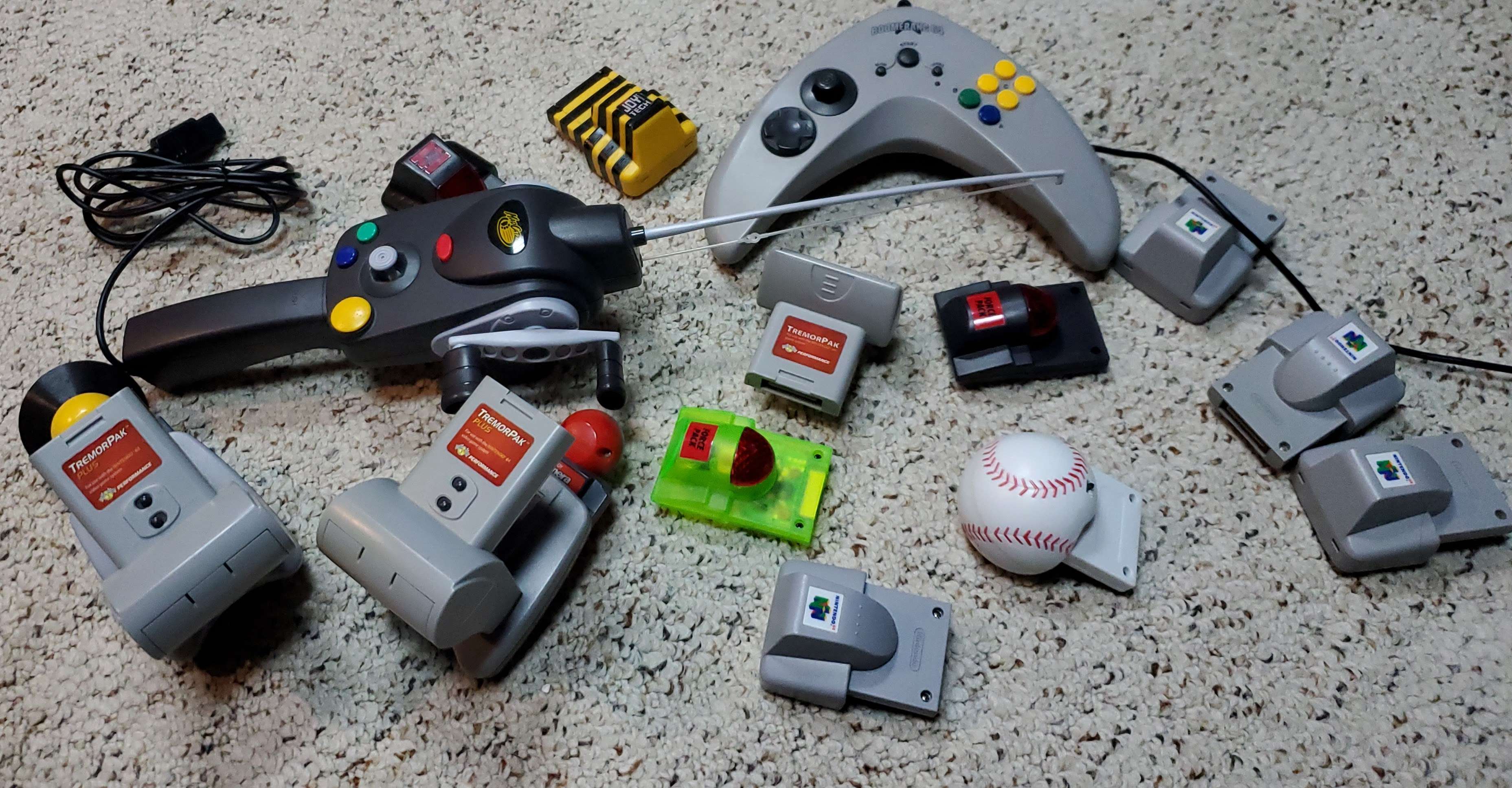 A collection of different N64 Rumble Paks and Controller Accessories